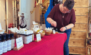 stella noverraz installant des produits d’aromathérapie Mini-Druide sur un stand